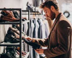 Young handsome man choosing shoes at a shop Young handsome man choosing shoes at a shop